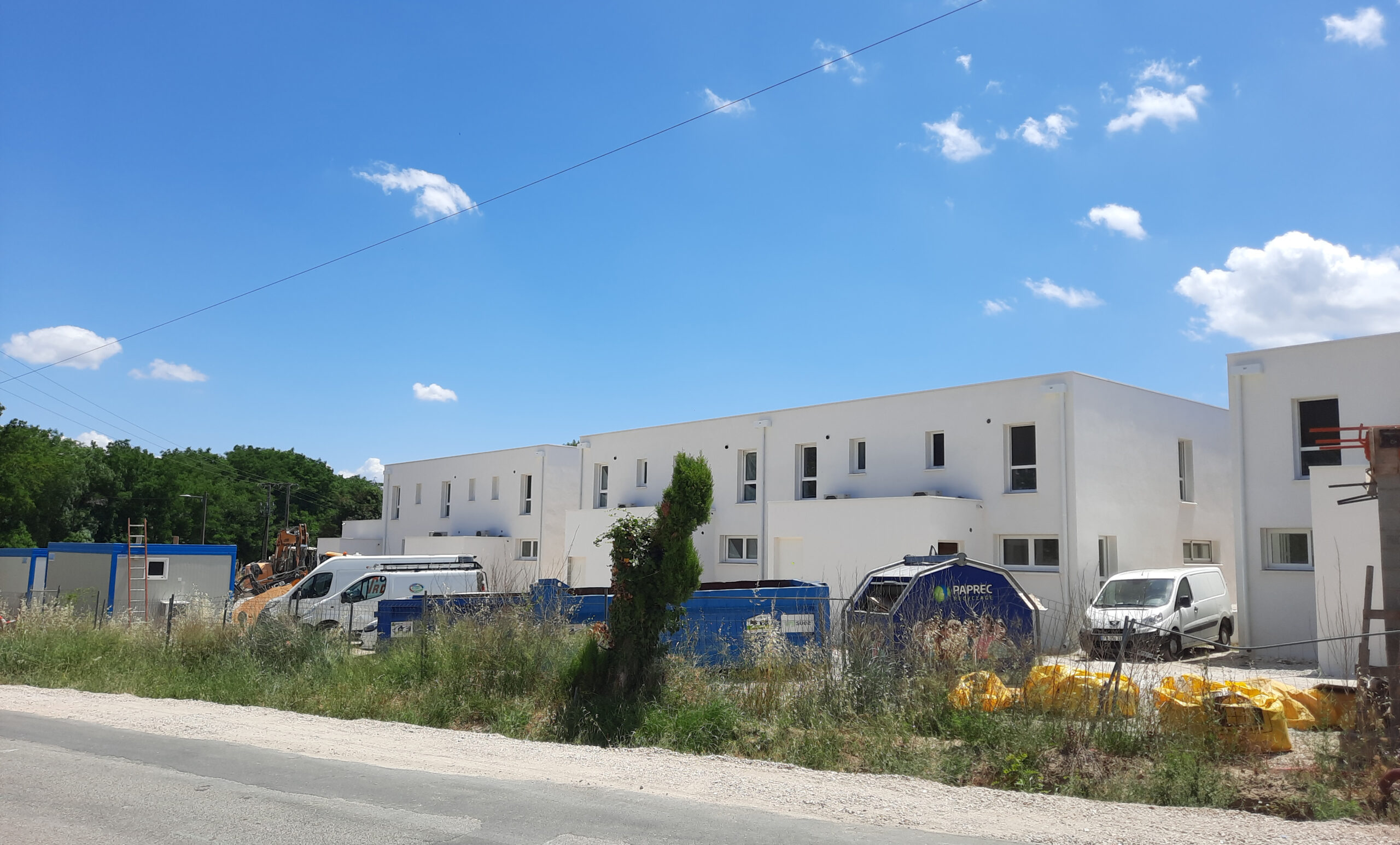 Les logements de la gendarmerie achevés, façades blanches, vus depuis la route